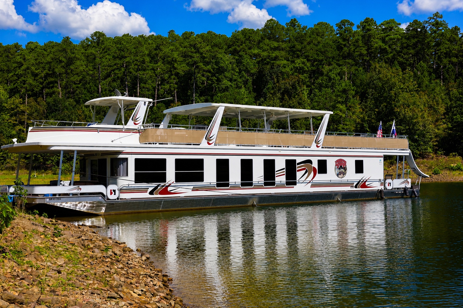 Full port-side profile of the 91-foot Sharpe houseboat on sunny Lake DeGray